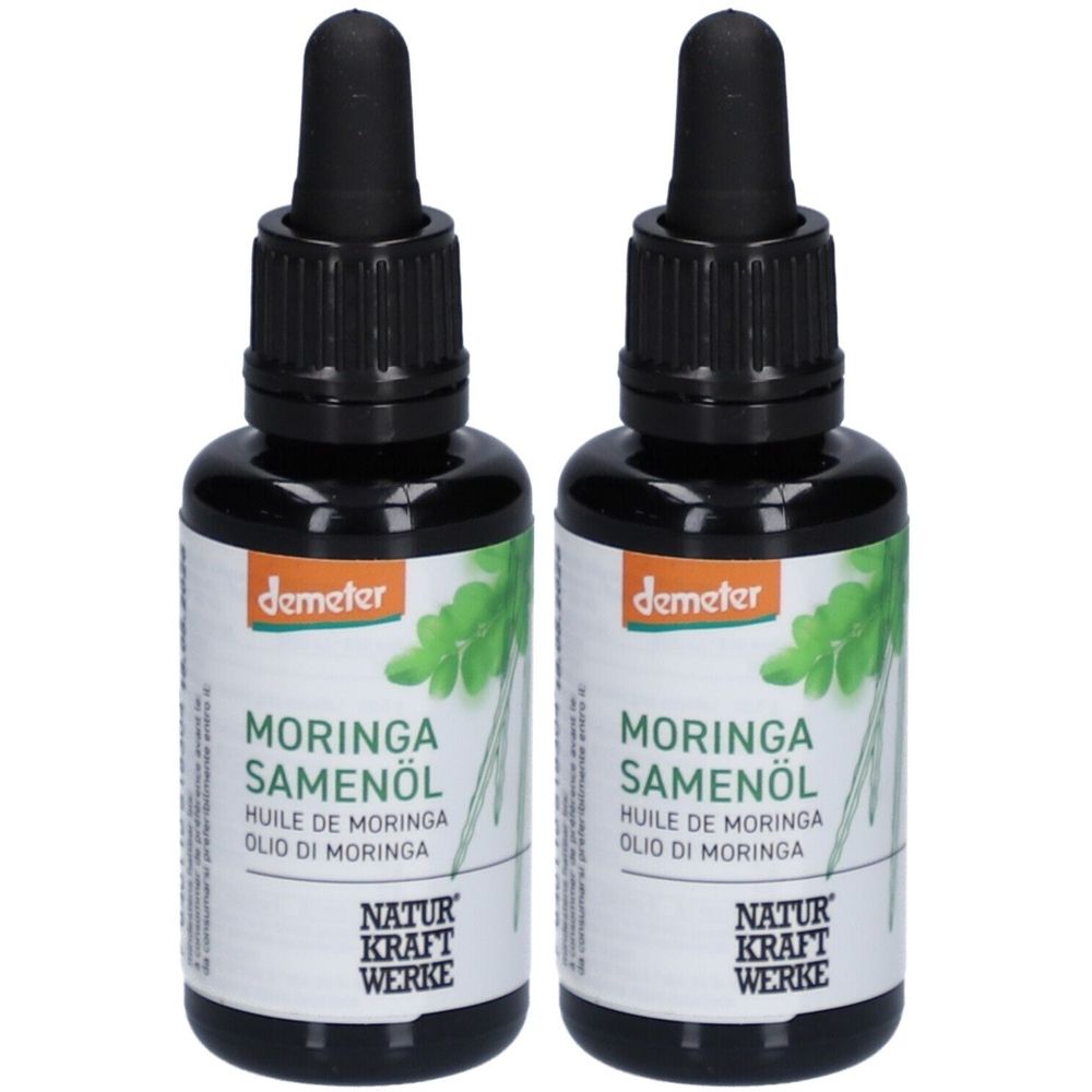 Deux flacons d'huile de graines de Moringa avec bouchon noir et étiquette. Inscription : Demeter, Moringa Samenöl, Natur Kraft Werke.