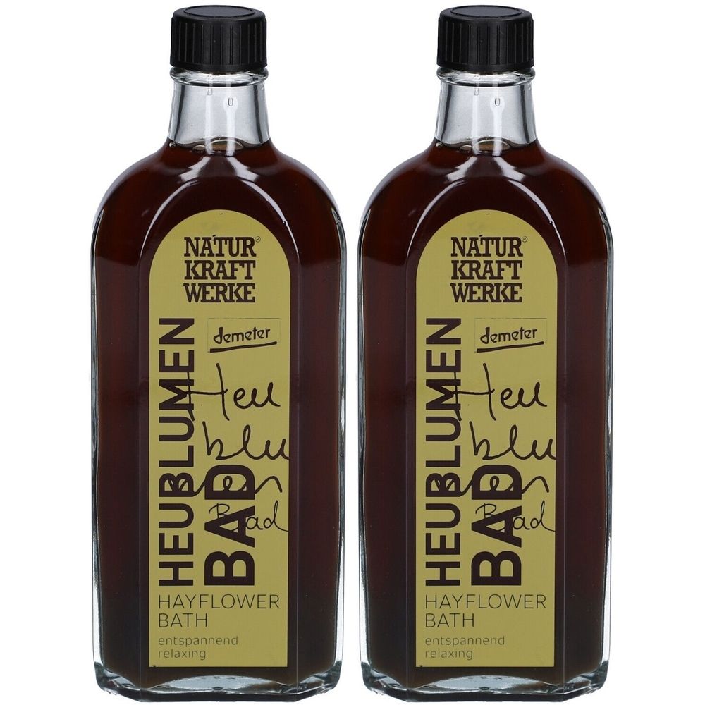Deux flacons de liquide brun. Étiquettes : Naturkraftwerke, Heublumen Bad, label Demeter. Bouchons à vis noirs.