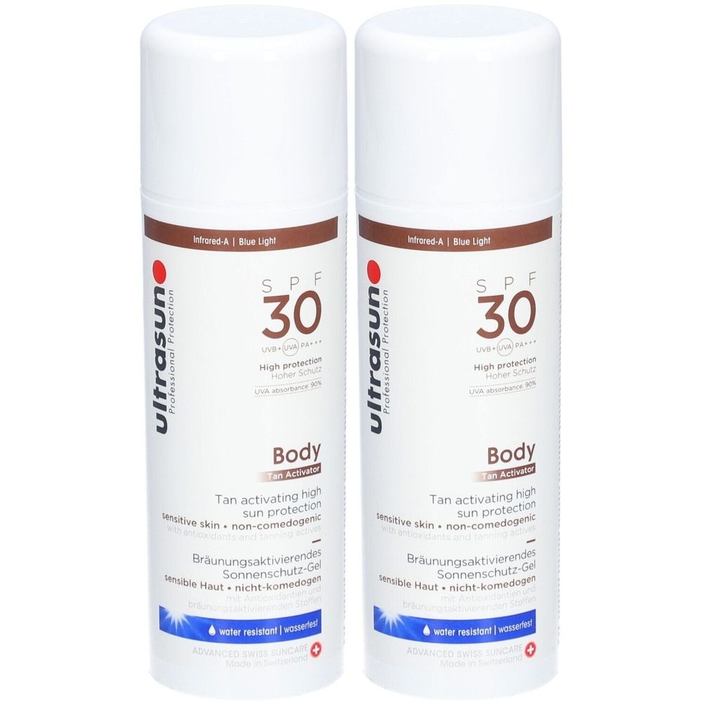 Deux flacons spray blancs avec accents marron. Inscription : ultrasun SPF 30 Body. Contient du texte en allemand et en anglais.