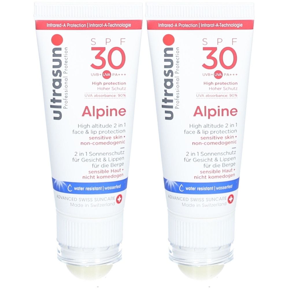 Deux tubes de crème solaire. Blanc, avec texte rouge et bleu. Inscription: SPF 30, Alpine, résistant à l'eau.