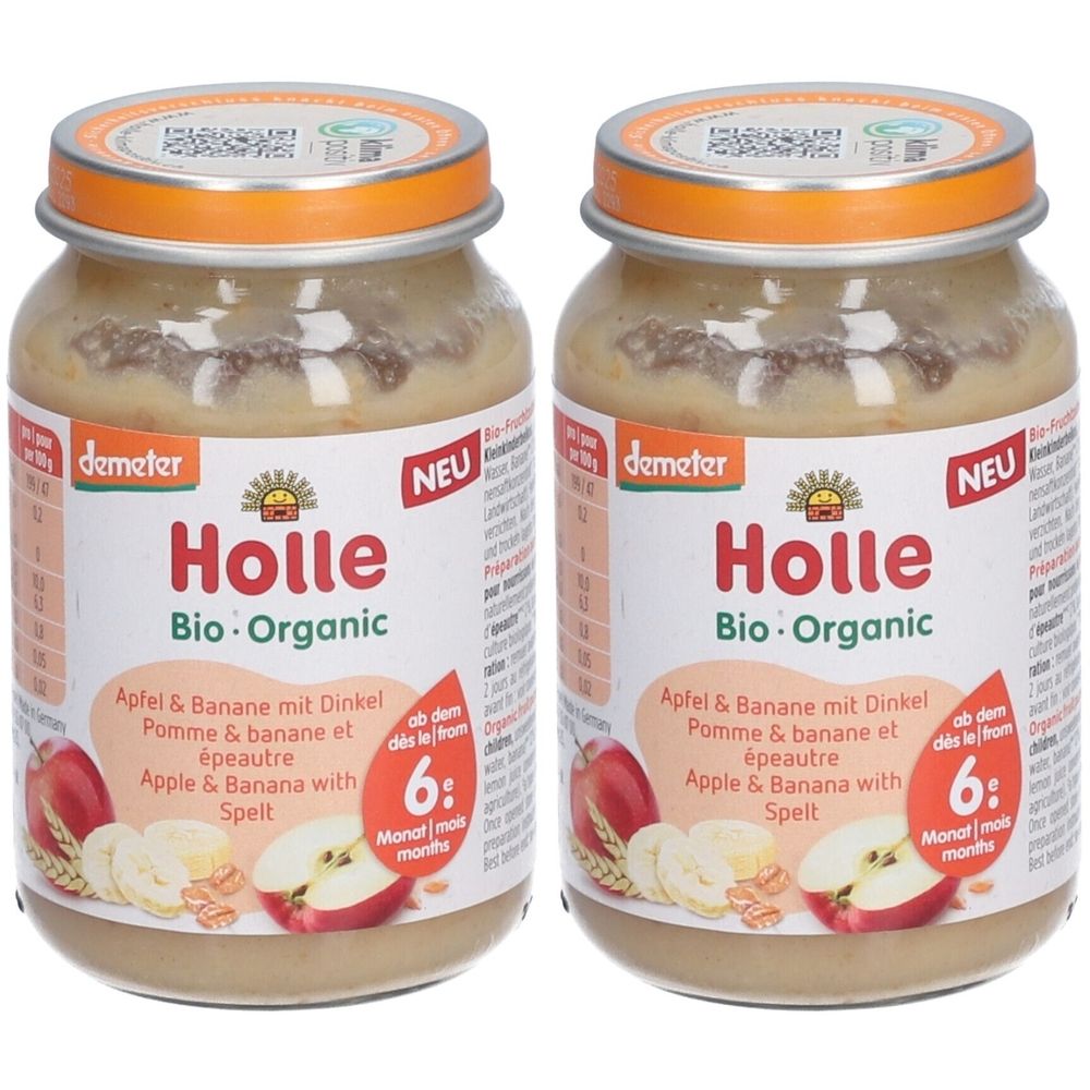 Deux pots de Holle Bio-Organic Pomme & Banane avec Épeautre. Pots avec couvercles orange et étiquettes avec informations et le label Demeter.