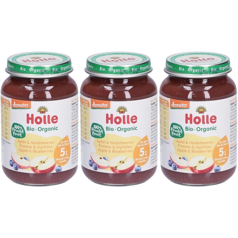 Trois pots de purée pour bébé Holle Bio-Organic avec pomme et myrtilles. Label Demeter. Couvercles verts, contenu brun, étiquette blanche.
