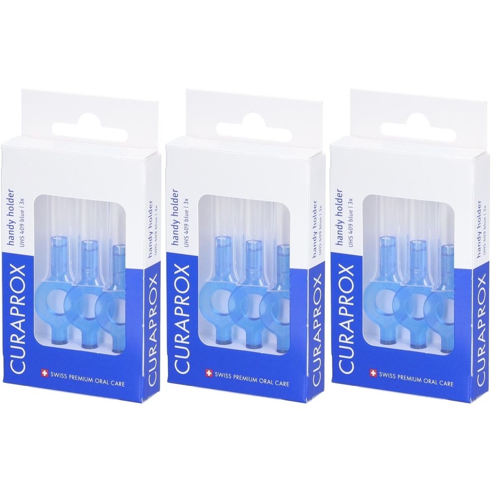 Trois boîtes de supports de brosse interdentaire bleus. L'emballage affiche la marque CURAPROX et le texte "handy holder".