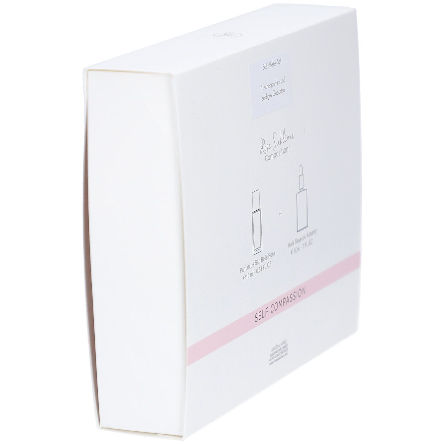 Dos incliné du coffret blanc. Inscription : Rose Sublime, Self Compassion. Illustration de deux flacons.