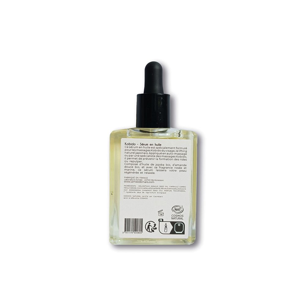 Vue arrière d'un flacon carré de sérum huileux. Étiquette avec texte et code-barres. Compte-gouttes noir.