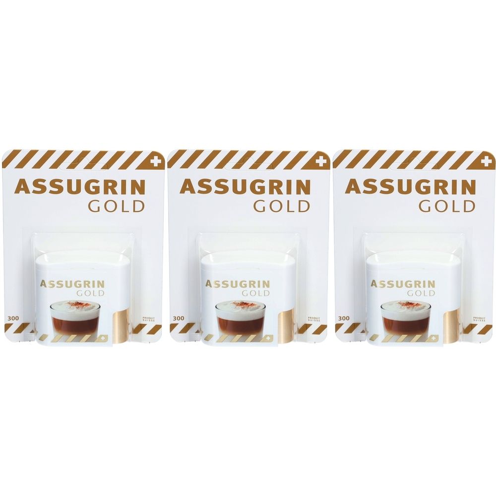 Trois emballages de comprimés édulcorants Assugrin Gold. Chaque emballage montre le produit dans une tasse. Le nom de la marque est visible.