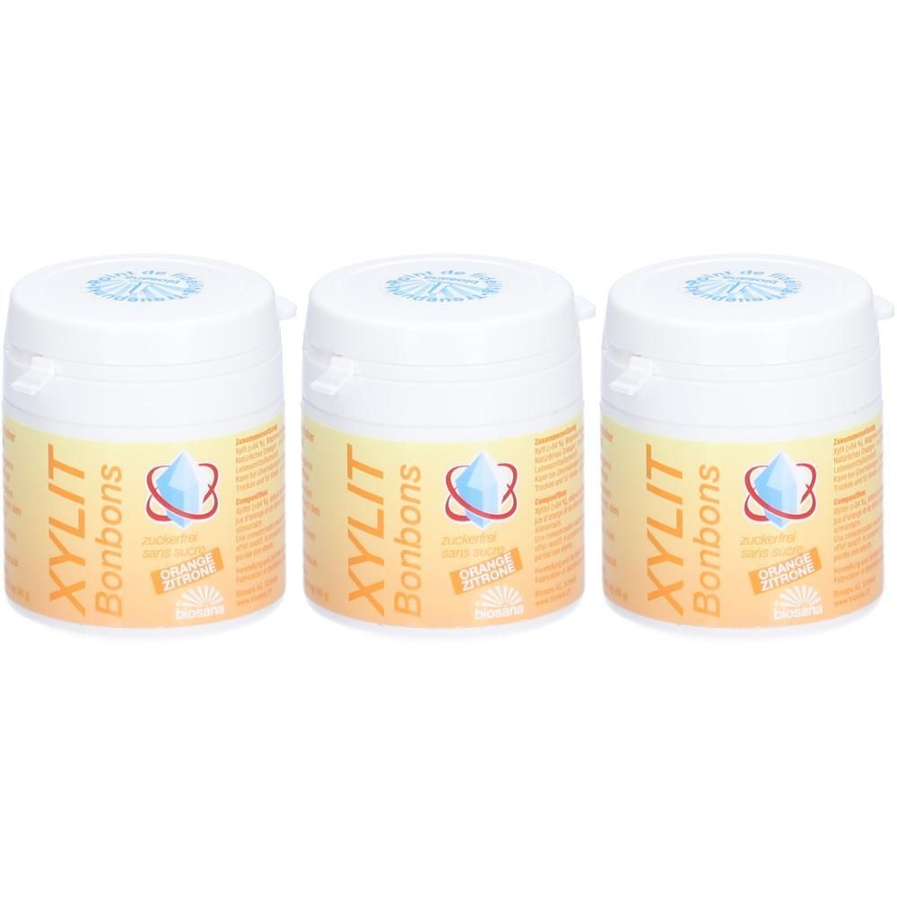 Trois contenants de pastilles XYLIT Orange/Citron. Contenants blancs avec étiquette orange-jaune.