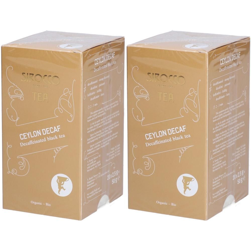 Deux boîtes dorées avec l'inscription "Ceylon Decaf". Visibles : logo, texte et label bio.