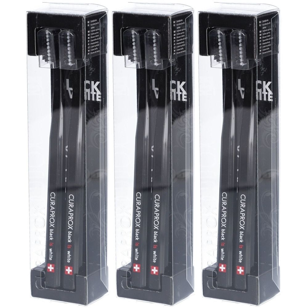 Trois brosses à dents noires dans des emballages transparents. Le texte "CURAPROX black is white" est visible.