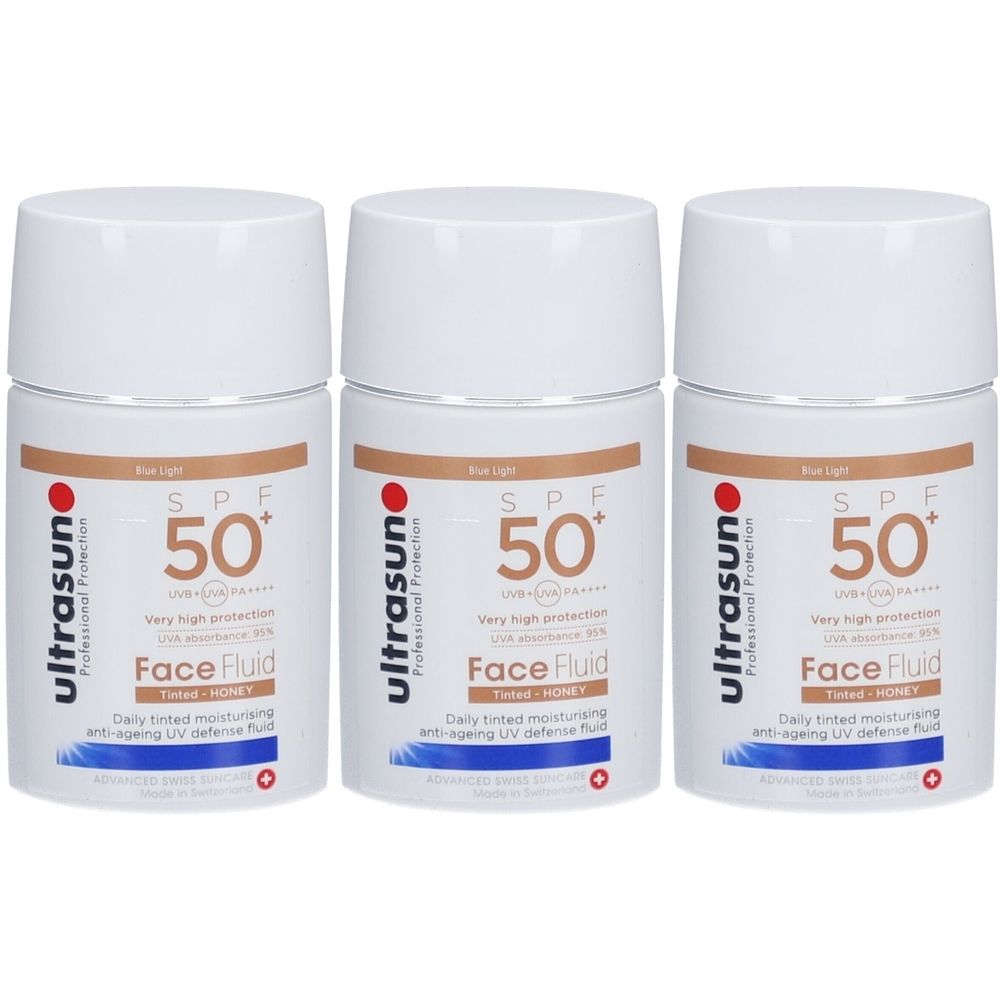 Trois flacons blancs avec couvercles. Inscription : ultrasun, SPF 50+, Face Fluid. Fluide teinté hydratant anti-âge de défense UV.