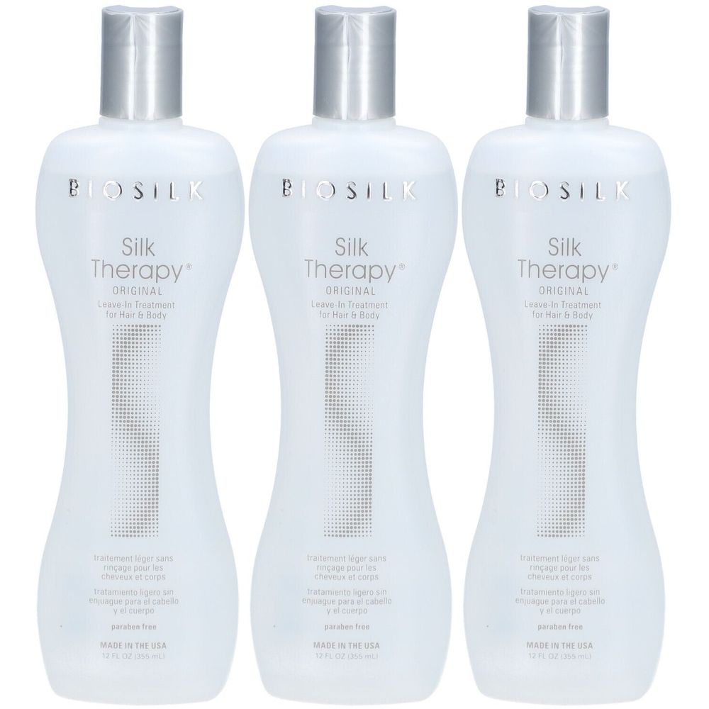 Trois flacons de BioSilk Silk Therapy Original. Flacons blancs avec bouchons argentés. Texte : Silk Therapy Original, Leave-in Treatment.