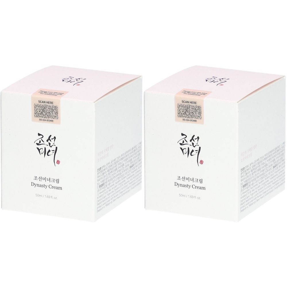 Deux boîtes carrées blanches avec couvercles roses. Texte coréen et anglais sur le devant, dont "Dynasty Cream". Un autocollant avec code QR est visible.