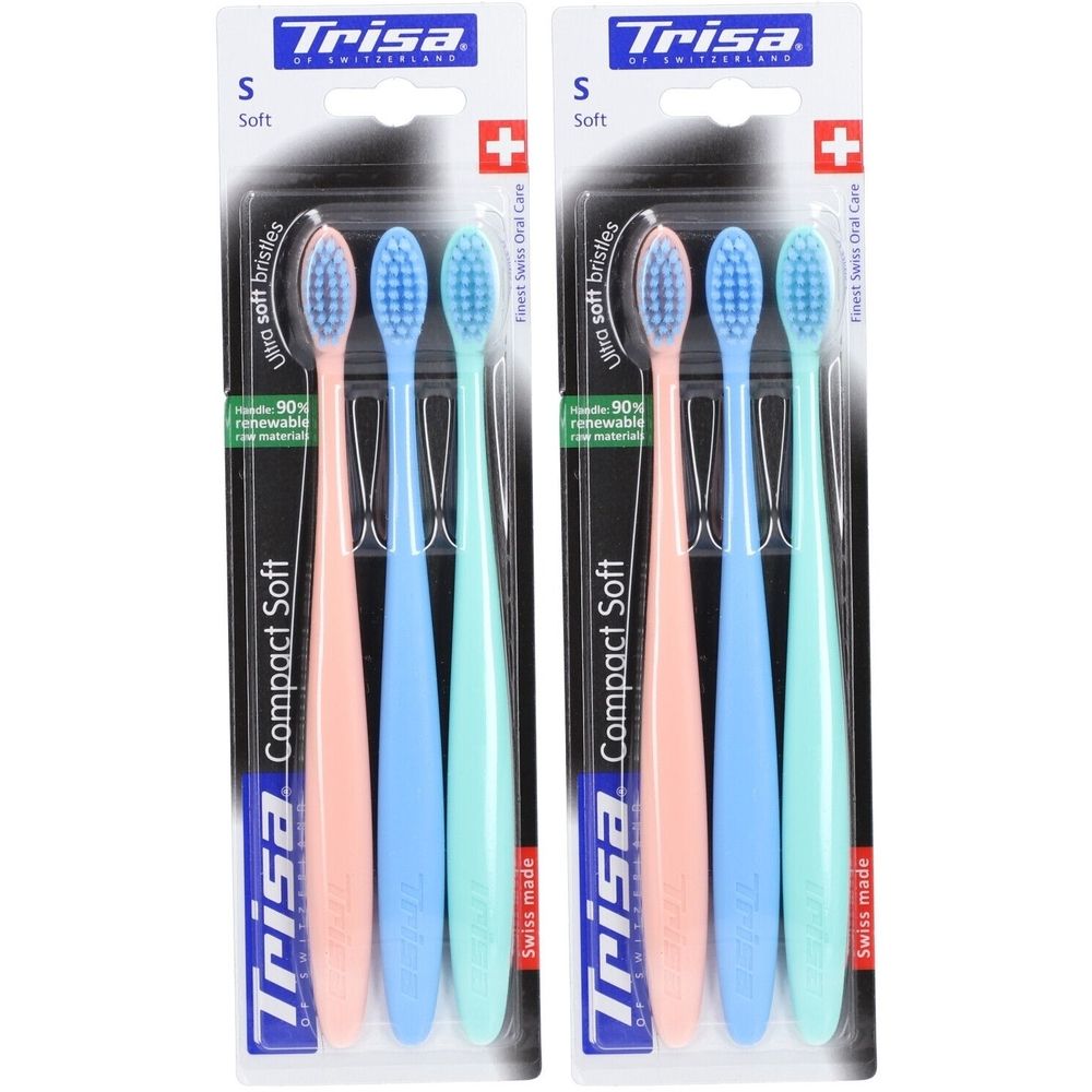 Deux paquets de brosses à dents Trisa Compact Soft. Chaque paquet contient trois brosses à dents roses, bleues et vertes.