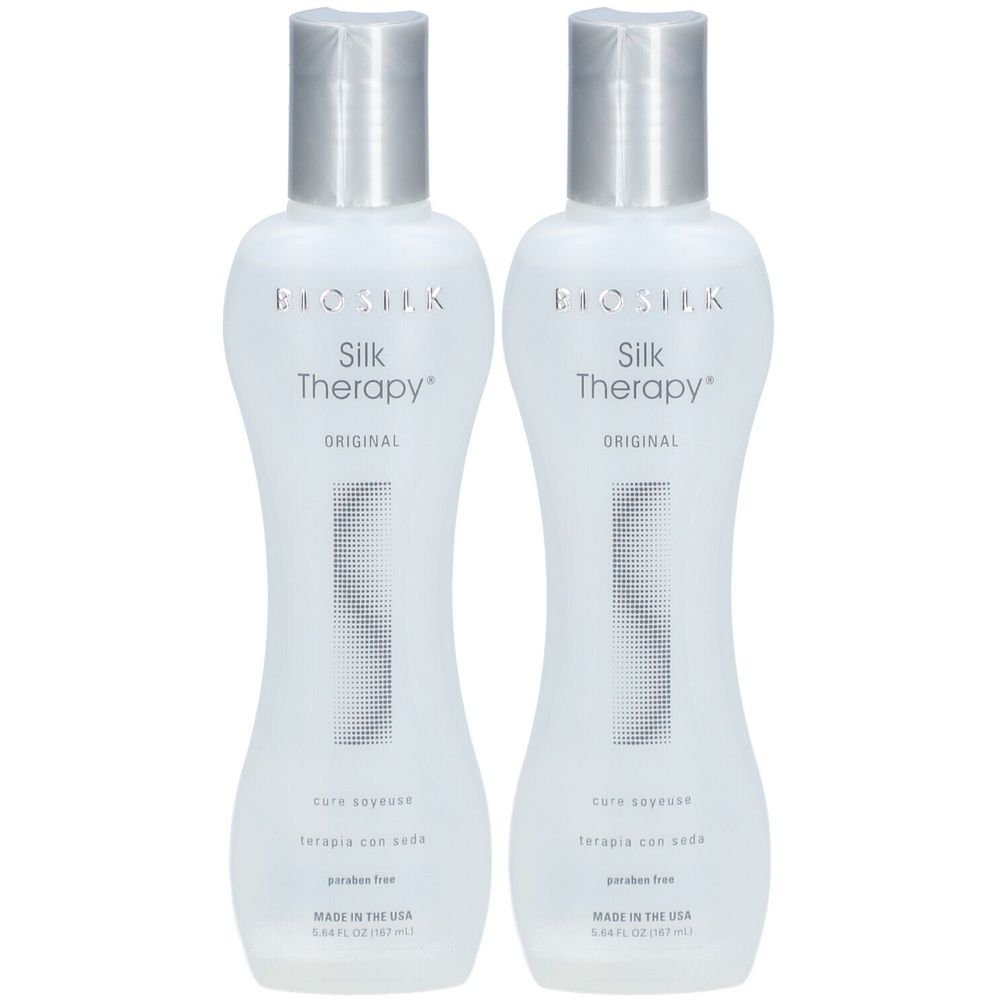 Deux flacons de BioSilk Silk Therapy. Flacons blancs avec bouchons argentés. Inscription : Silk Therapy, Original, sans paraben.