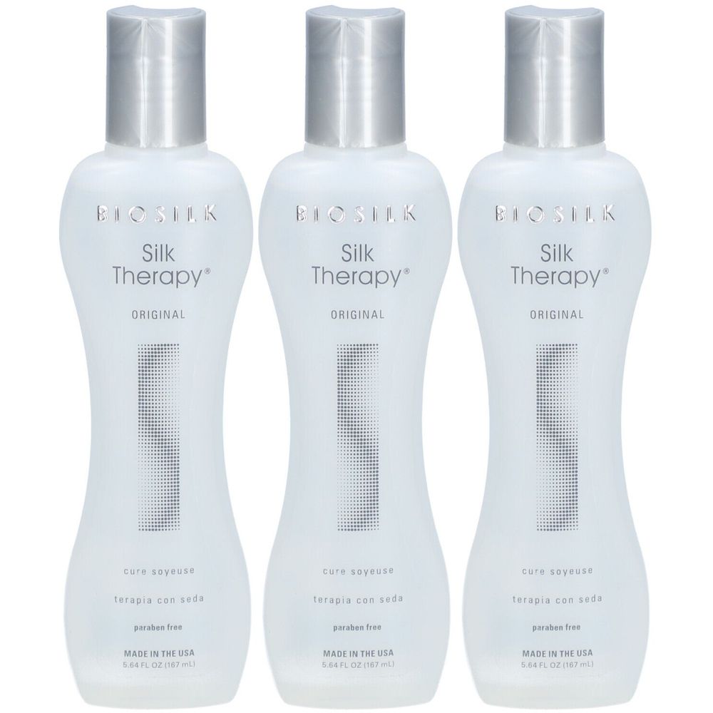 Trois flacons BioSilk Silk Therapy. Flacons blancs avec bouchons argentés. Inscription : Silk Therapy, Original, pure soie/terapia con seda, sans paraben.
