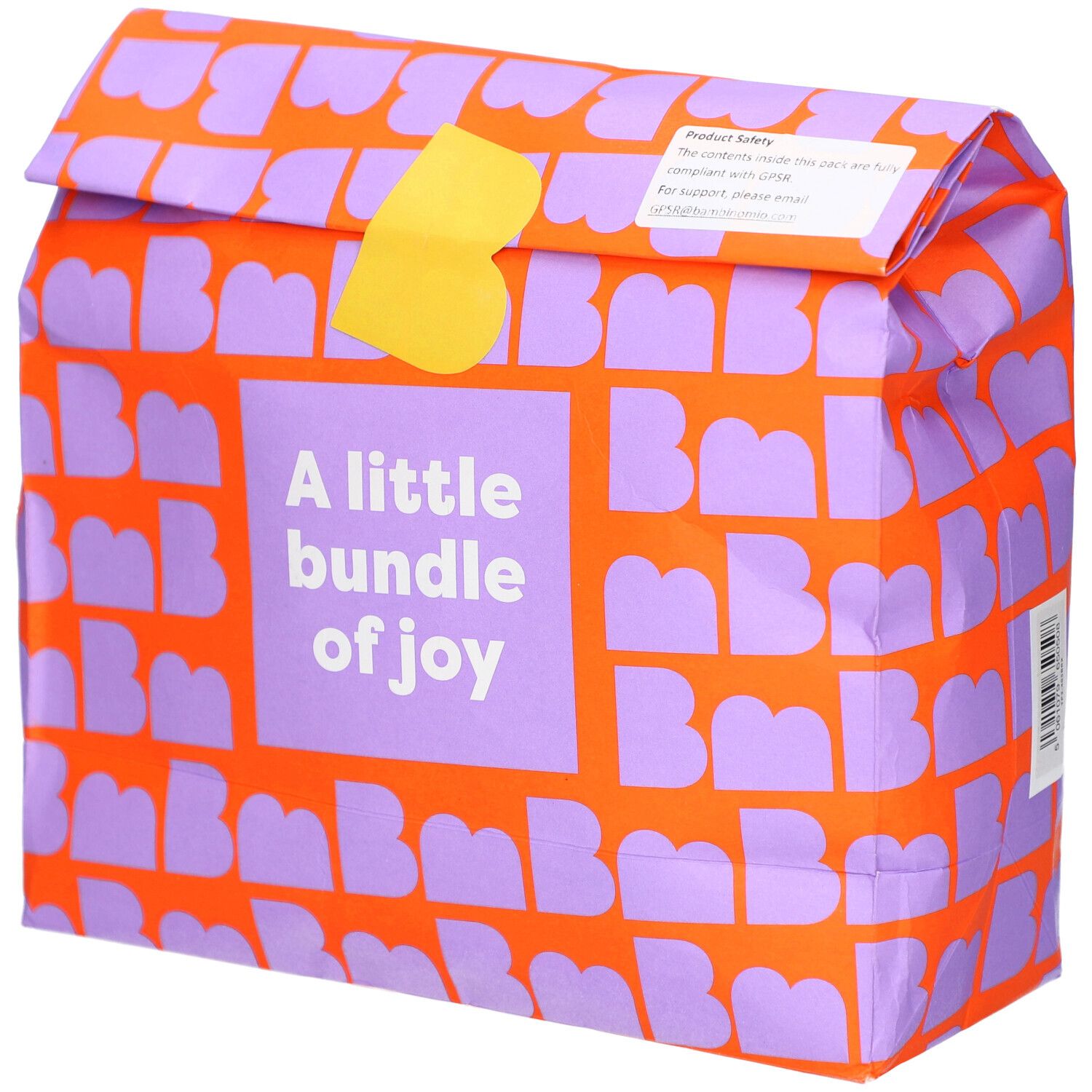 Emballage orange à motifs violets. Texte: A little bundle of joy. Fermeture jaune.