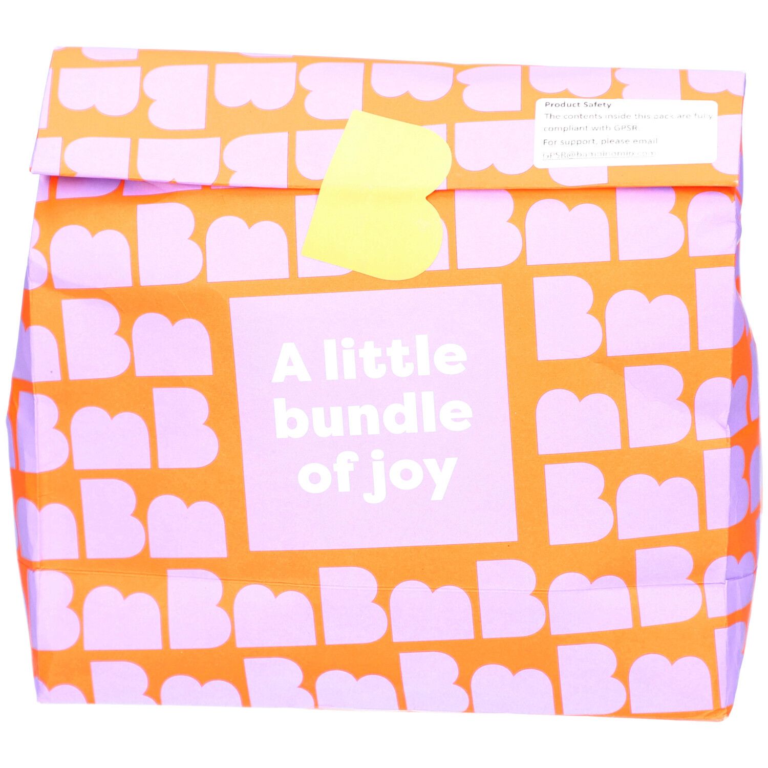 Emballage orange à motifs violets. Texte: A little bundle of joy. Fermeture jaune.