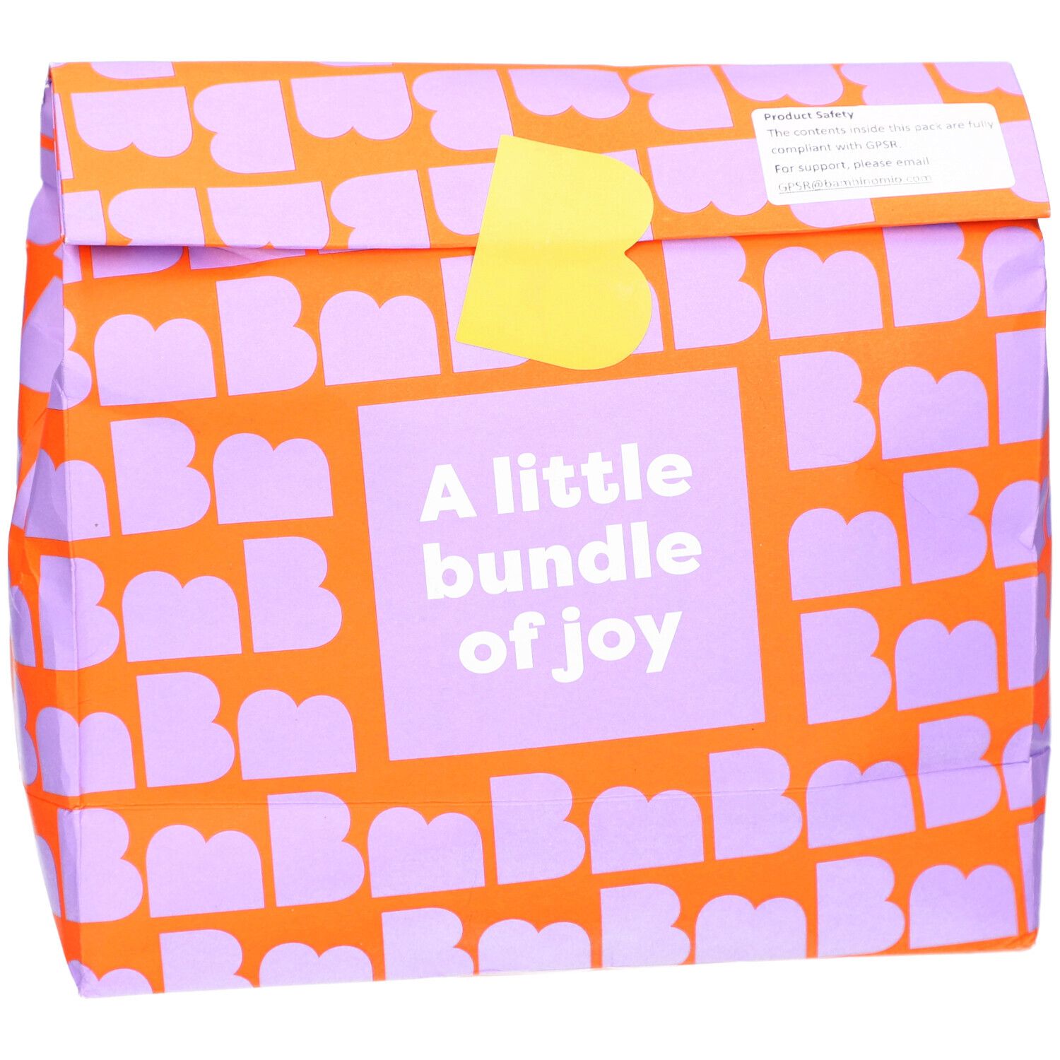 Emballage orange à motifs violets. Texte: A little bundle of joy. Fermeture jaune.