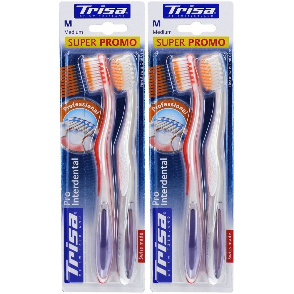 Deux brosses à dents sous blister. Marque Trisa, modèle Pro Interdental. Soies Medium, têtes orange, manches rouges et blancs.