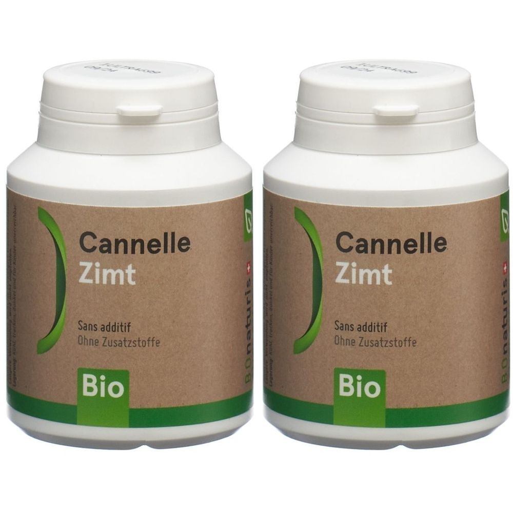 Deux flacons blancs avec des étiquettes marron. Sur les étiquettes, on peut lire "Cannelle Zimt", "Sans additif", "Ohne Zusatzstoffe" et "Bio".