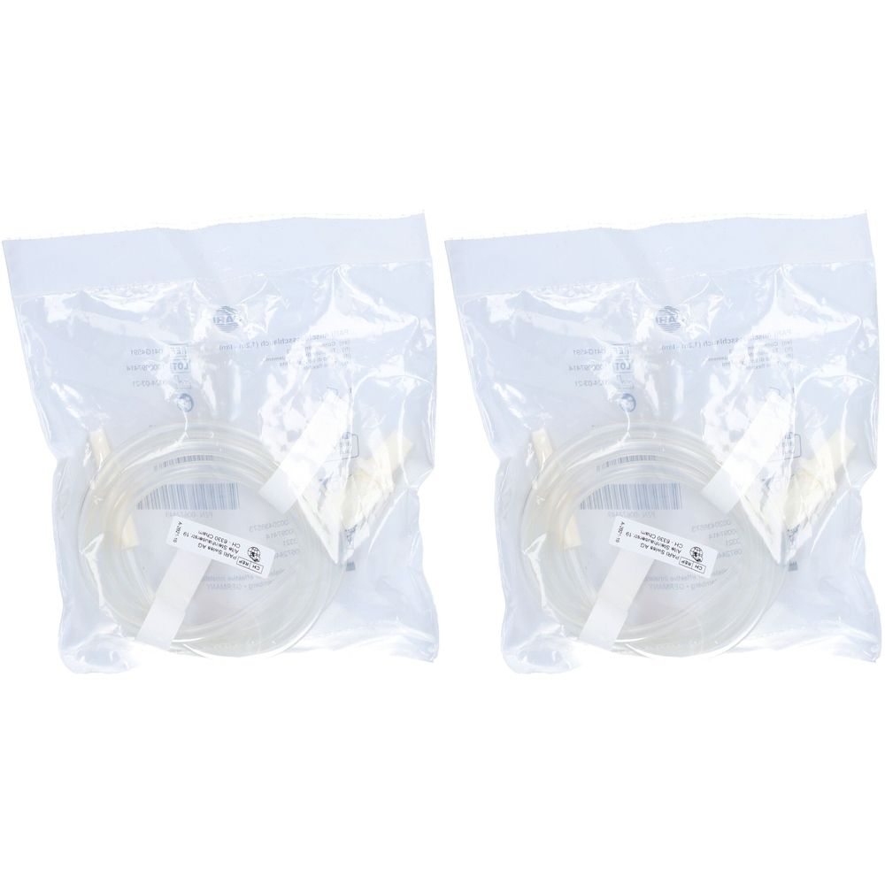 Deux tubes transparents dans un emballage plastique. Étiquettes avec texte. Raccords jaunâtres aux extrémités.