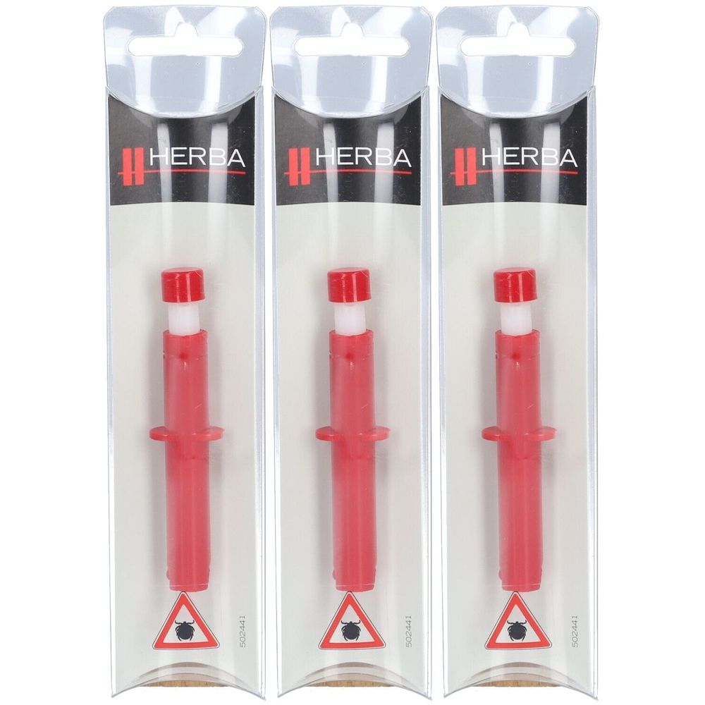 Trois pinces à tiques rouges en blister. Inscription HERBA. Avertissement avec tique.
