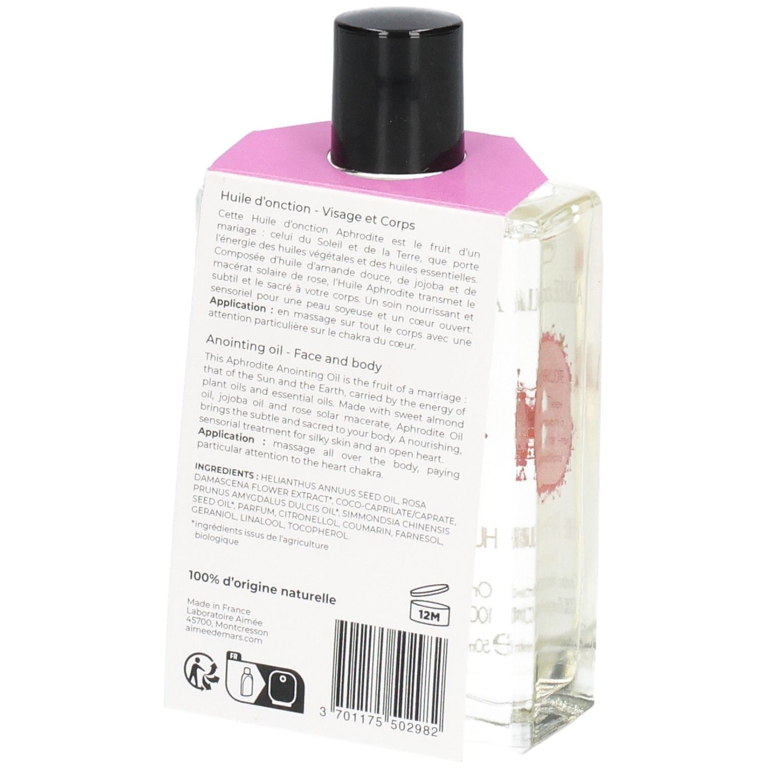 Flacon en verre avec liquide clair, bouchon noir et étiquette rose. Dos avec texte et code-barres.