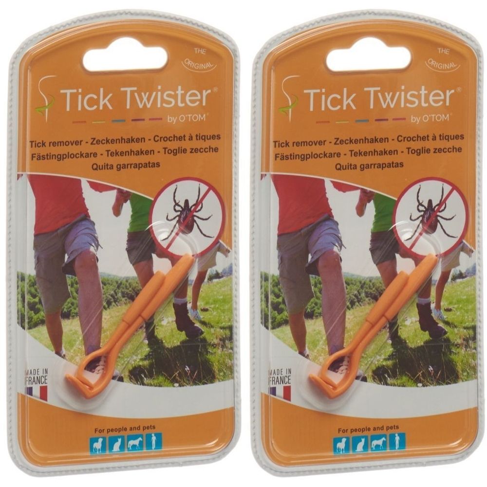 Deux emballages blister de Tick Twister by O'TOM. Outil orange pour enlever les tiques. Texte multilingue et illustration d'une tique barrée.