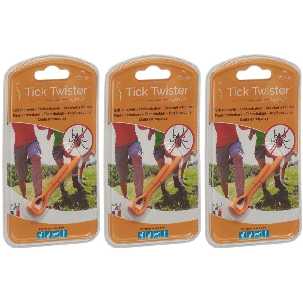 Trois crochets à tiques orange dans un emballage blister. L'emballage porte la mention "Tick Twister" et "by O'TOM".