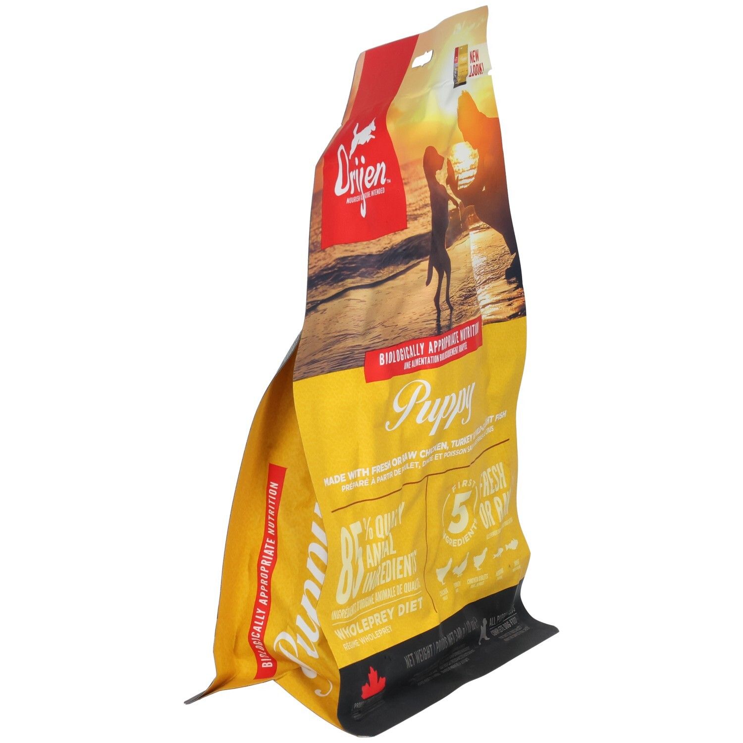 Sac ORIJEN jaune en biais. Logo et texte: Puppy, 85% ingrédients animaux. Dos avec liste d'ingrédients et illustrations de viande.