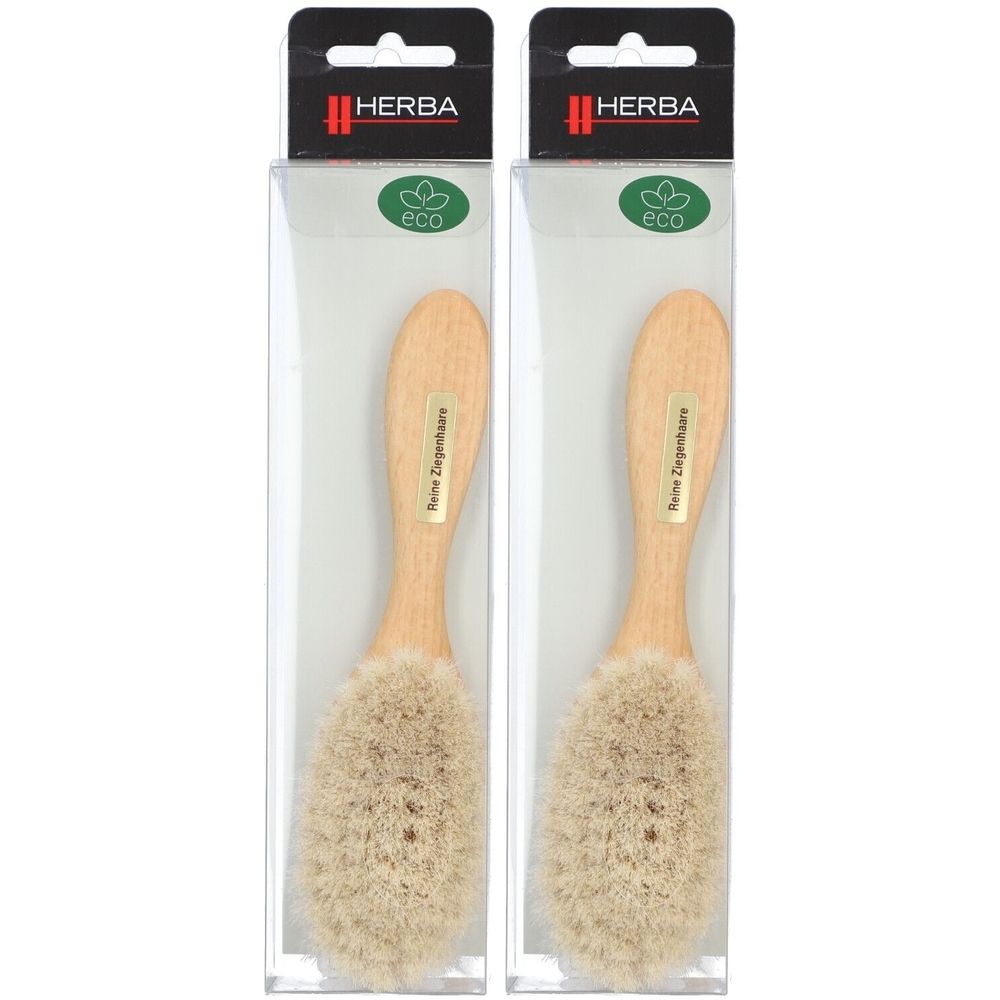 Deux brosses à bébé en emballage transparent. Manche en bois, poils clairs. Marque : HERBA. Avec label Eco.
