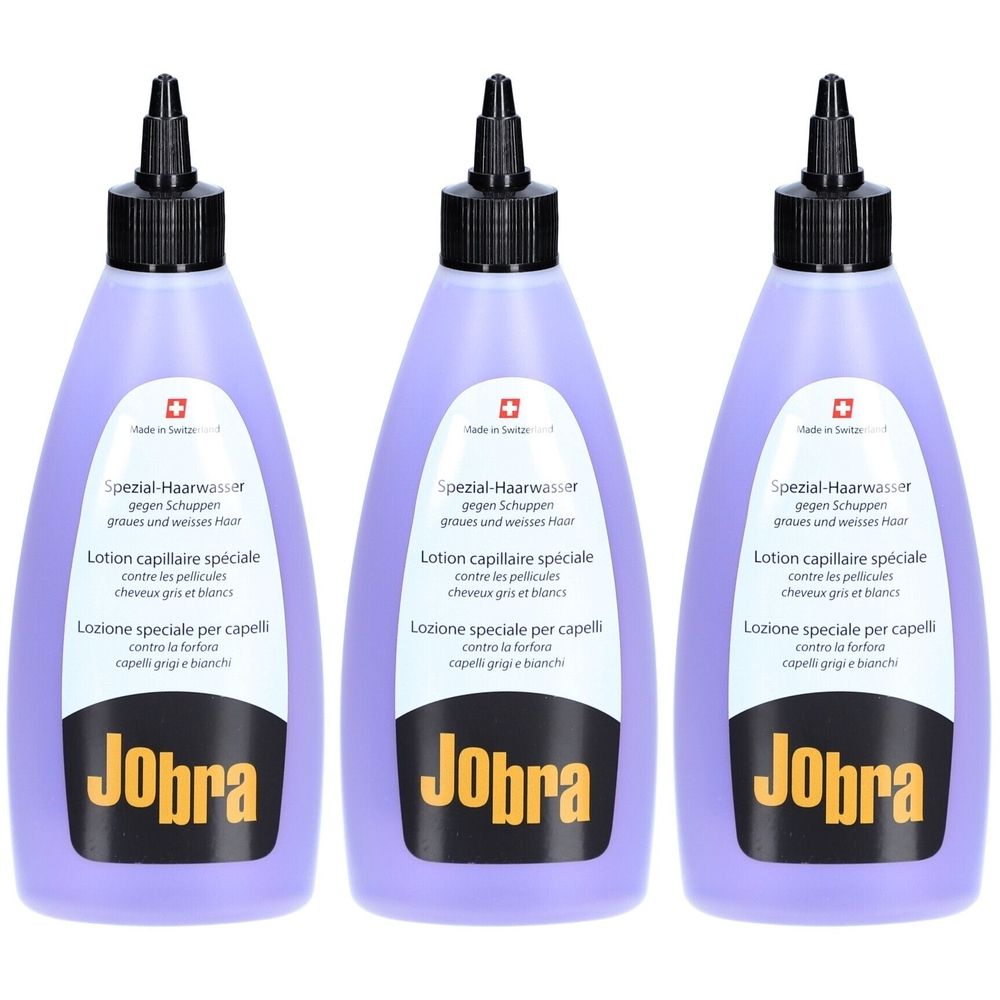 Trois flacons de liquide violet avec bouchon noir. Inscription : Jobra Spezial-Haarwasser contre les pellicules. Croix suisse.