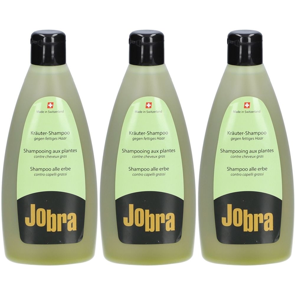 Trois flacons de shampooing verts avec bouchons noirs. Inscriptions : Jobra, Kräuter-Shampoo, Shampooing aux plantes, Shampoo alle erbe.