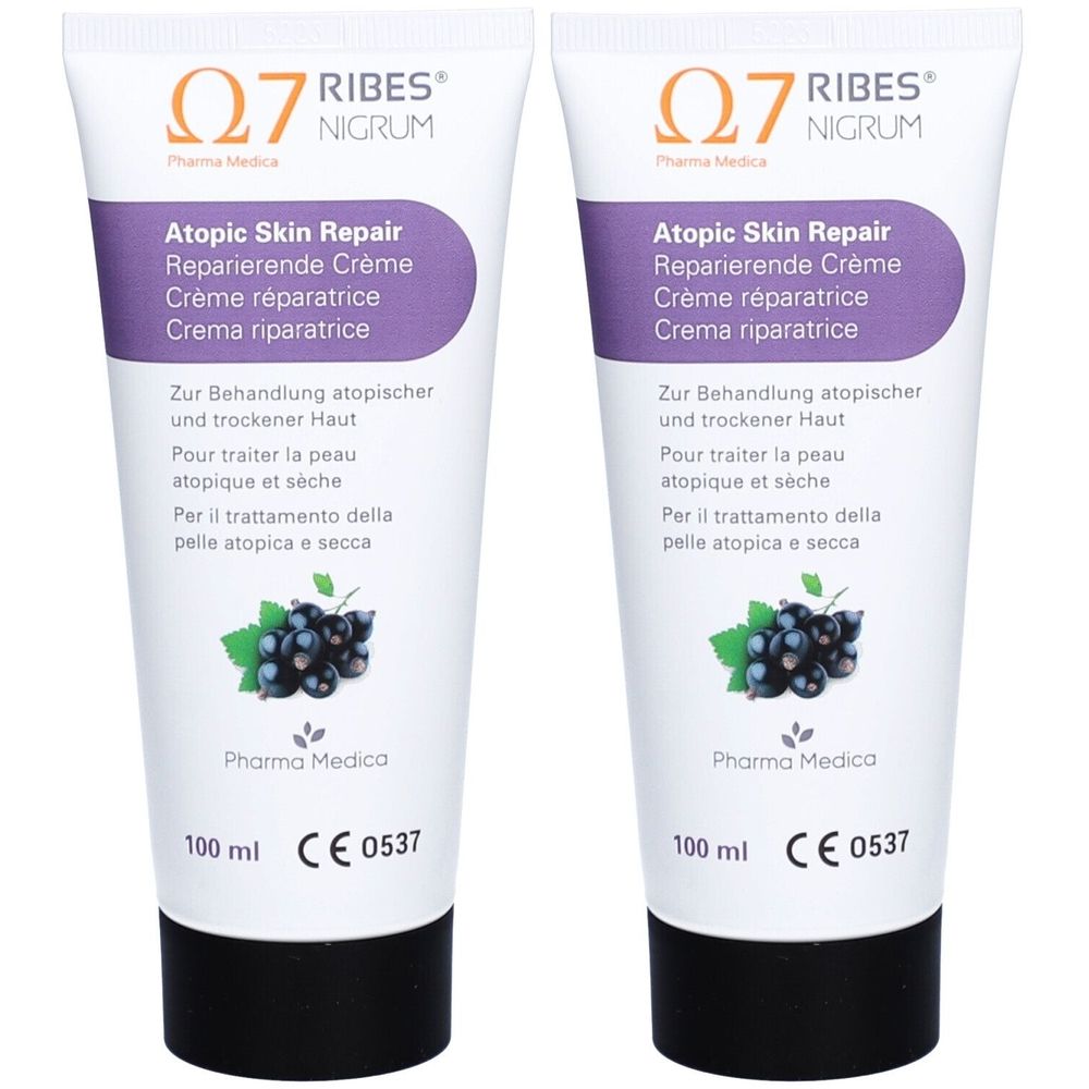 Deux tubes de crème. Inscription: Atopic Skin Repair, Crème réparatrice. Illustration de cassis. Marquage CE.