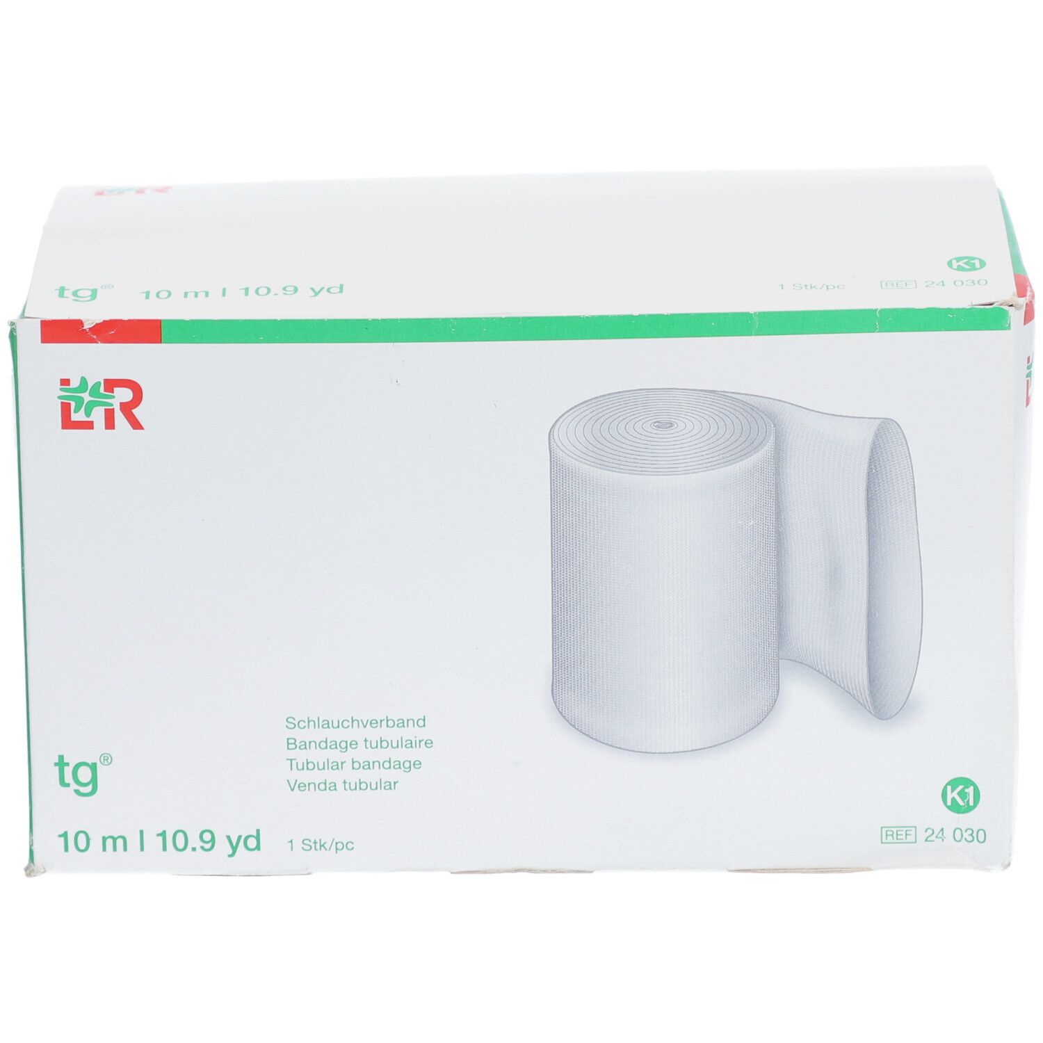 tg® Bandage tubulaire en emballage. Bande blanche, 10 m. Inscriptions : tg®, 10 m | 10.9 yd, K1.