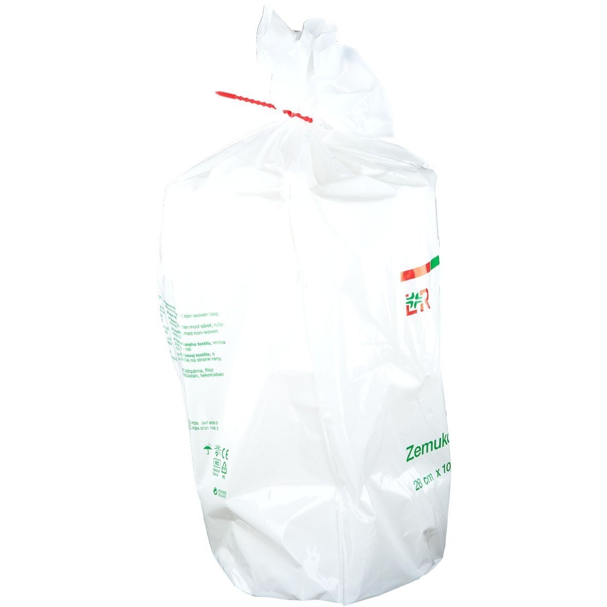 Emballage plastique avec compresse. Fermeture rouge. Inscriptions vertes. Texte en allemand, anglais, français, espagnol.