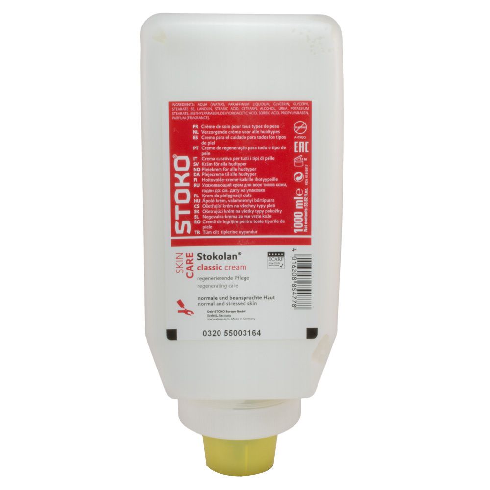 Distributeur de crème Stokolan Classic. Récipient blanc avec étiquette rouge. Sortie jaune. Texte : Stokolan, Skin Care, classic cream.
