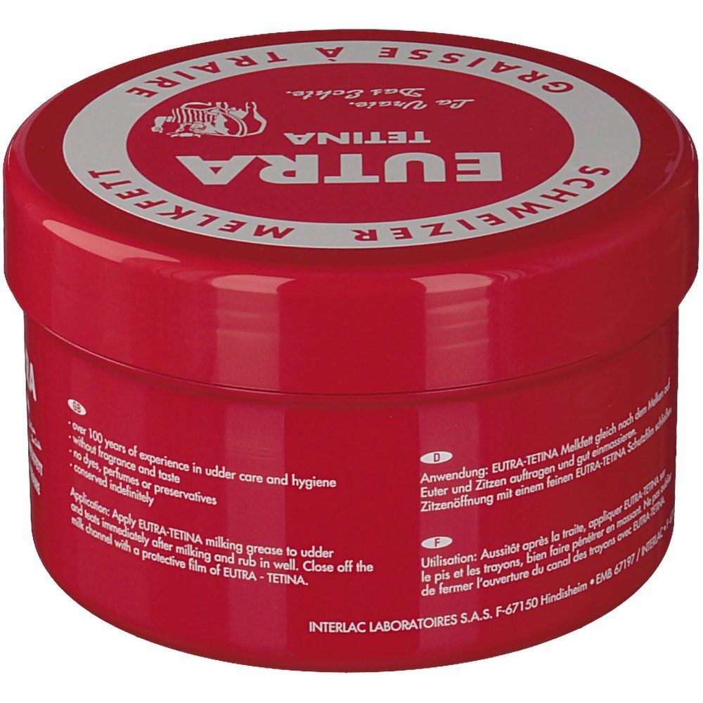 Pot rouge avec couvercle blanc. Inscription: Eutra Tetina, Schweizer Melkfett, Graisse à Traire. Texte: Sans parfum, colorants, conservateurs. Instructions d'utilisation.