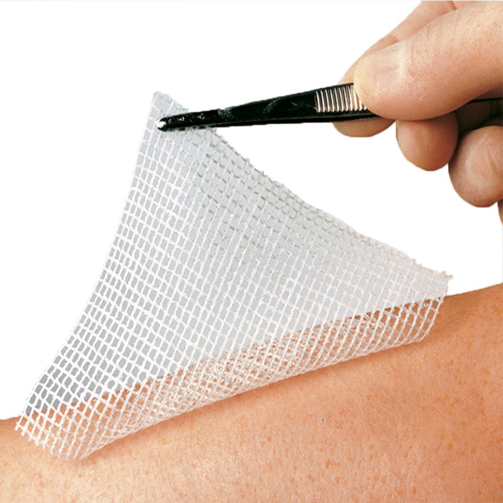 Compresse de gaze blanche, tenue par une pince sur un bras. Structure ouverte.