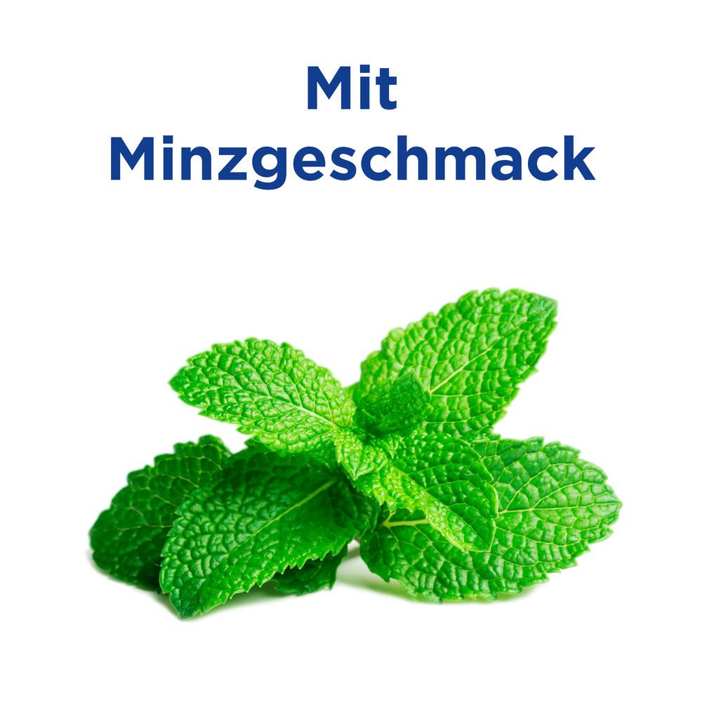 Gros plan sur des feuilles de menthe fraîche. Texte: Avec goût de menthe.