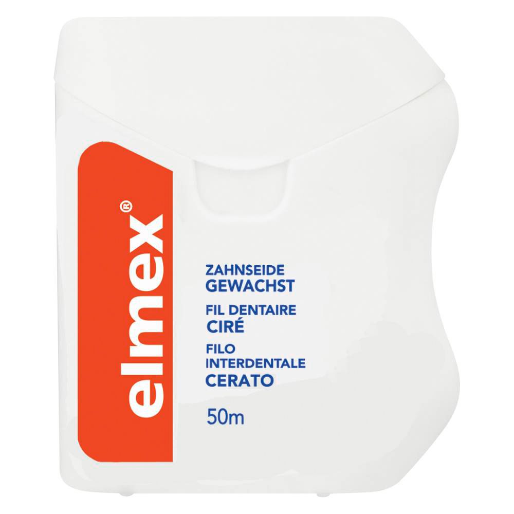 Boîtier blanc avec logo rouge Elmex. Texte: Fil dentaire ciré, 50m.
