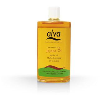 Flacon en verre jaune d'huile de jojoba. Inscription : alva Naturkosmetik, Hautpflege Jojoba-Öl. Avec des éléments verts et bruns.