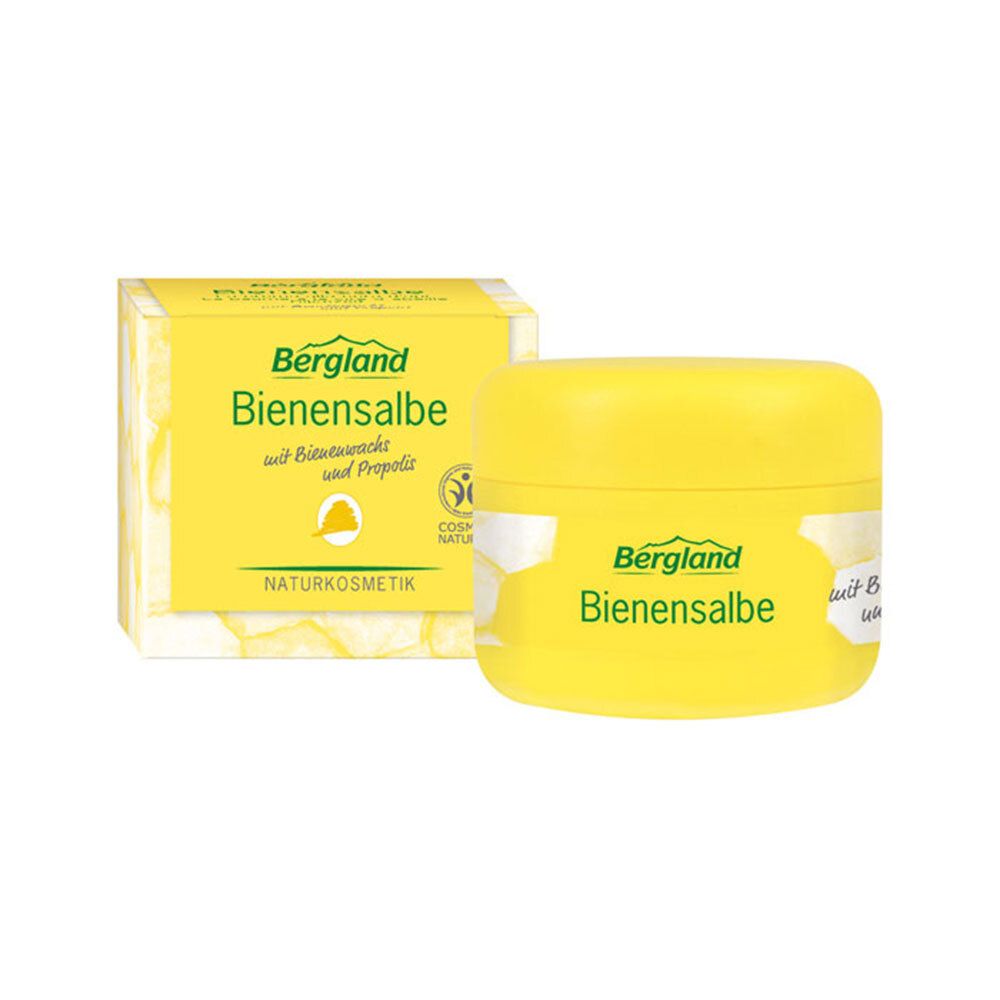 Pot et boîte jaunes avec l'inscription Bergland Bienensalbe. Cosmétiques naturels. Contient de la cire d'abeille et de la propolis.