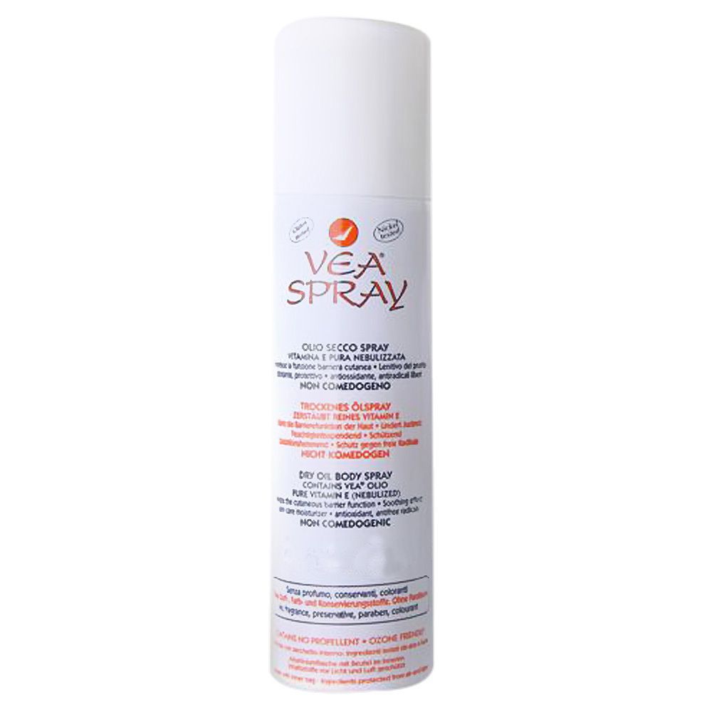 Flacon spray blanc avec texte rouge et noir. Inscription: VEA® SPRAY. Contient de l'huile sèche, vitamine E.