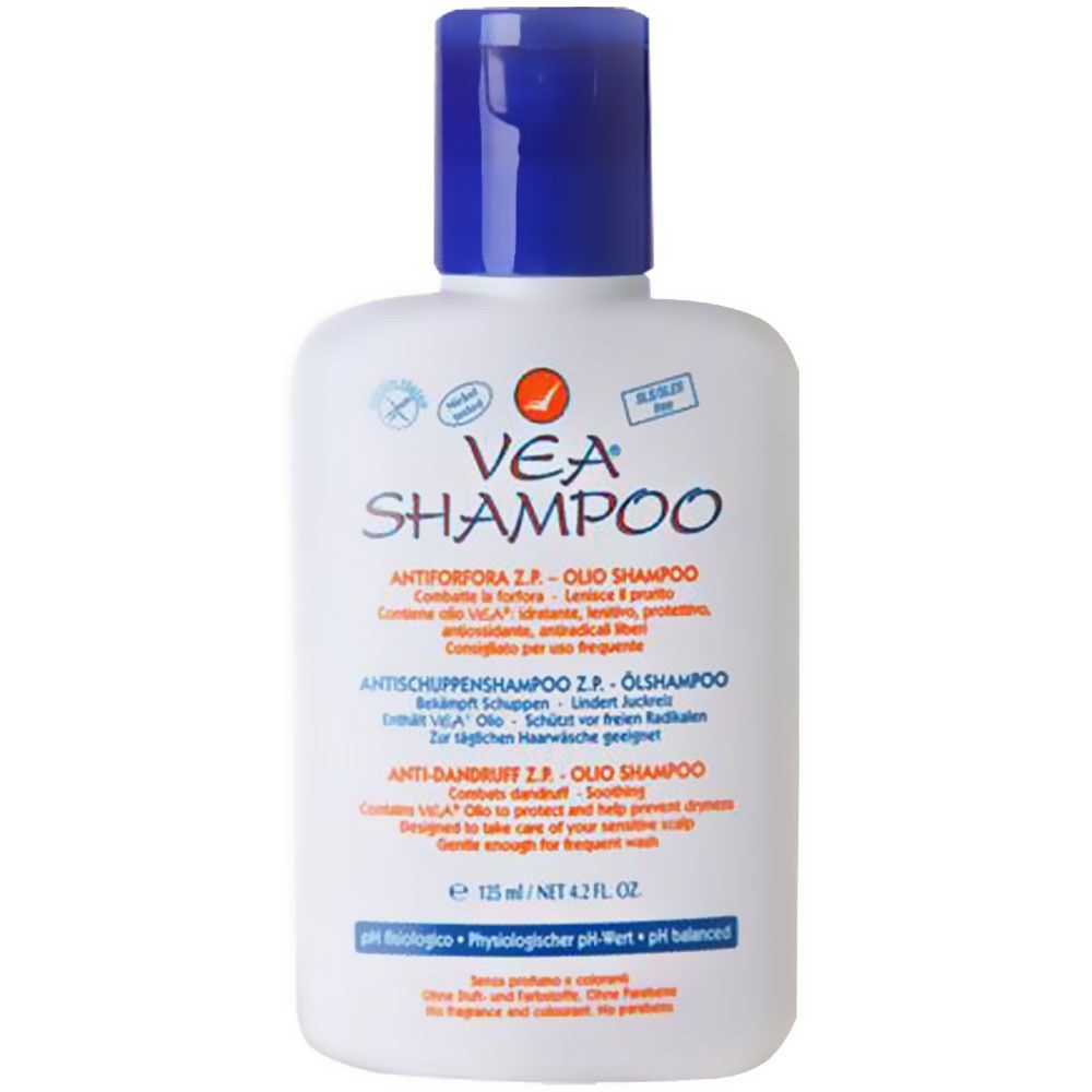 Flacon blanc avec bouchon bleu. Inscription VEA Shampoo. Texte multilingue. Logo orange.