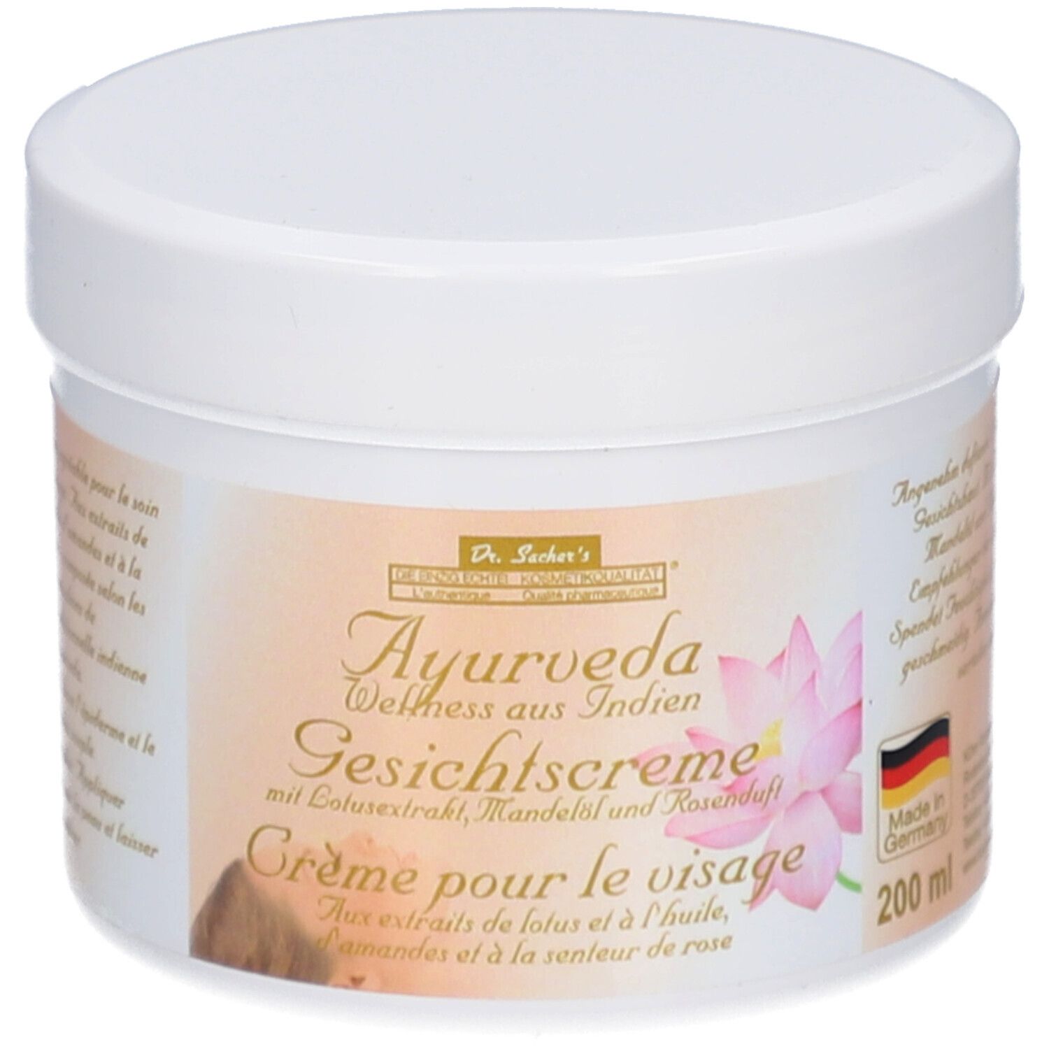 Pot blanc avec couvercle. Étiquette avec texte: Dr. Sacher's Ayurveda Crème pour le visage avec extrait de lotus, huile d'amande et parfum de rose.