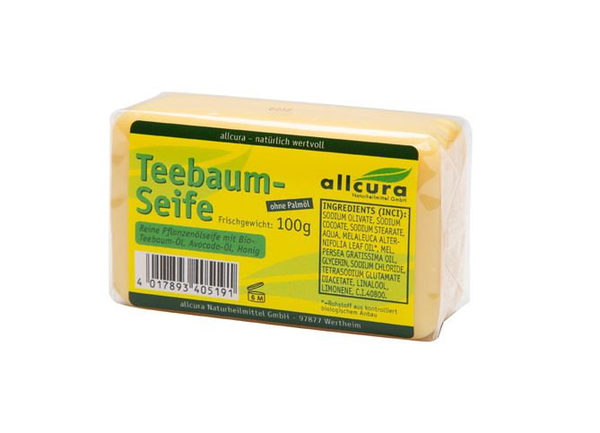 Savon jaune emballé. Inscription: Teebaum-Seife, allcura. Ingrédients et poids 100g.