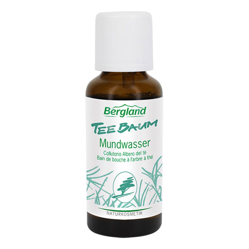 Flacon brun avec bouchon blanc. Inscription: Bergland Tee Baum Mundwasser. Étiquette verte et blanche avec logo.