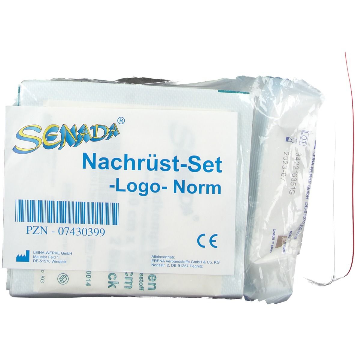 Emballage du kit de mise à niveau Senada -Logo- Norm. Contient plusieurs composants, dont un marquage CE et un code-barres. Élément fin rouge.