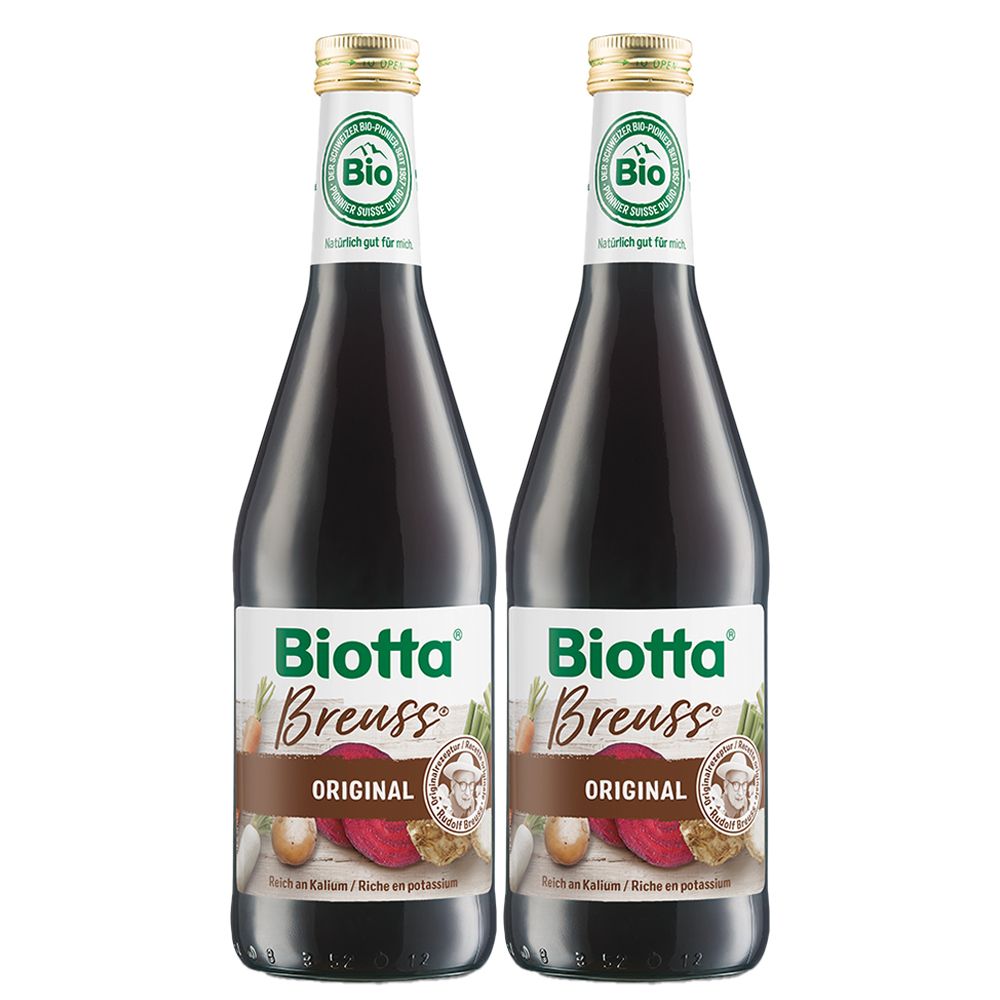 Deux bouteilles de Biotta Breuss. Liquide brun, label bio vert, étiquette avec illustrations de légumes.